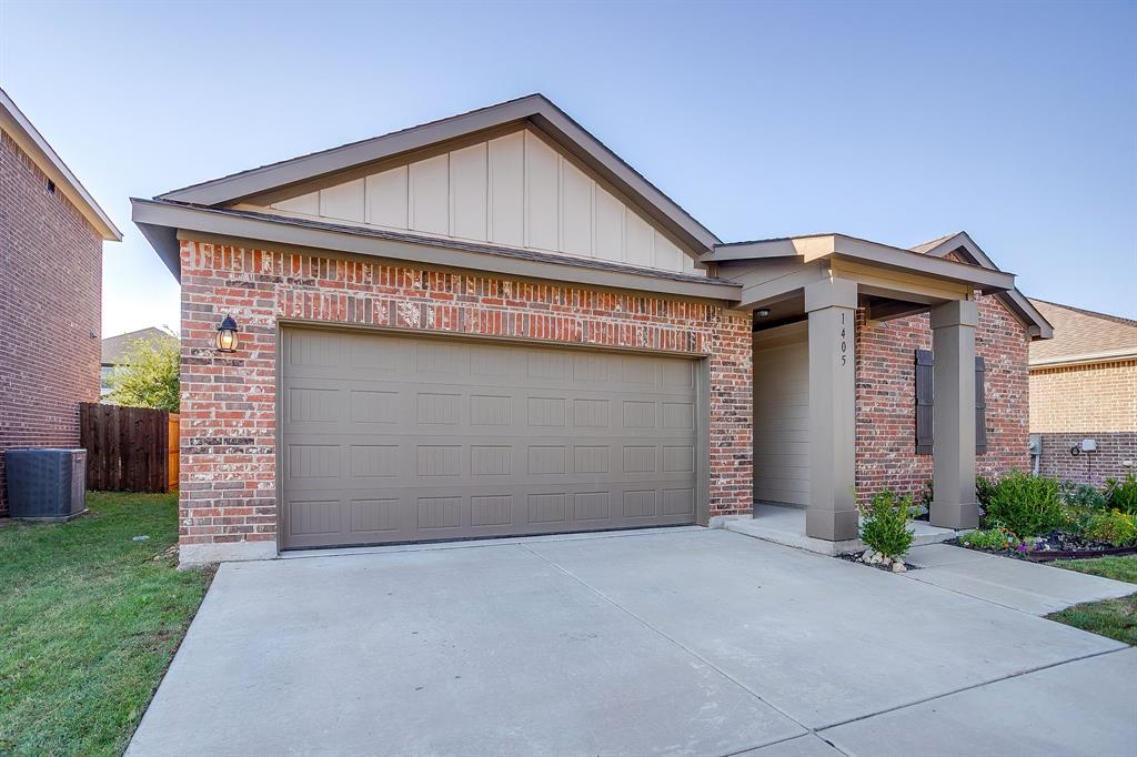 1405 Gentle Crk Lane Fort Worth, TX 76052 - Photo 3 of 40 a front view of a house with a yard and garage