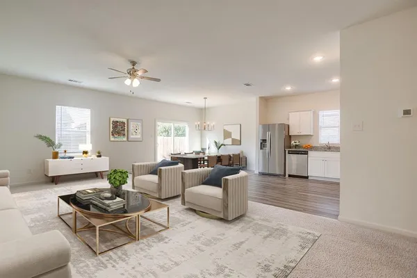 a living room with furniture and kitchen view