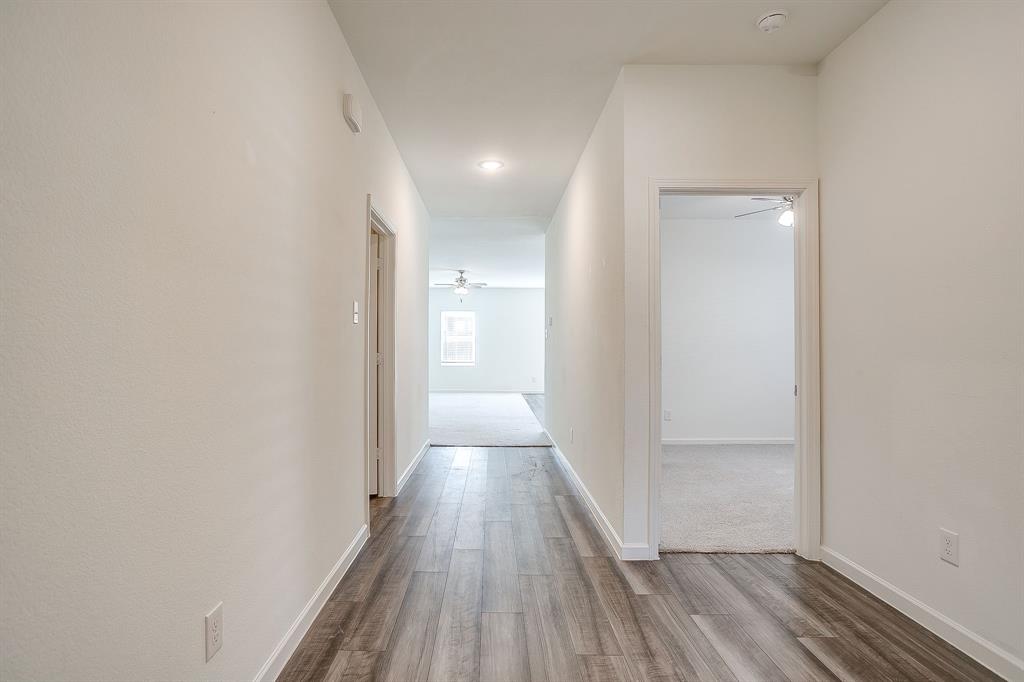 1405 Gentle Crk Lane Fort Worth, TX 76052 - Photo 9 of 40 a view of a hallway with wooden floor