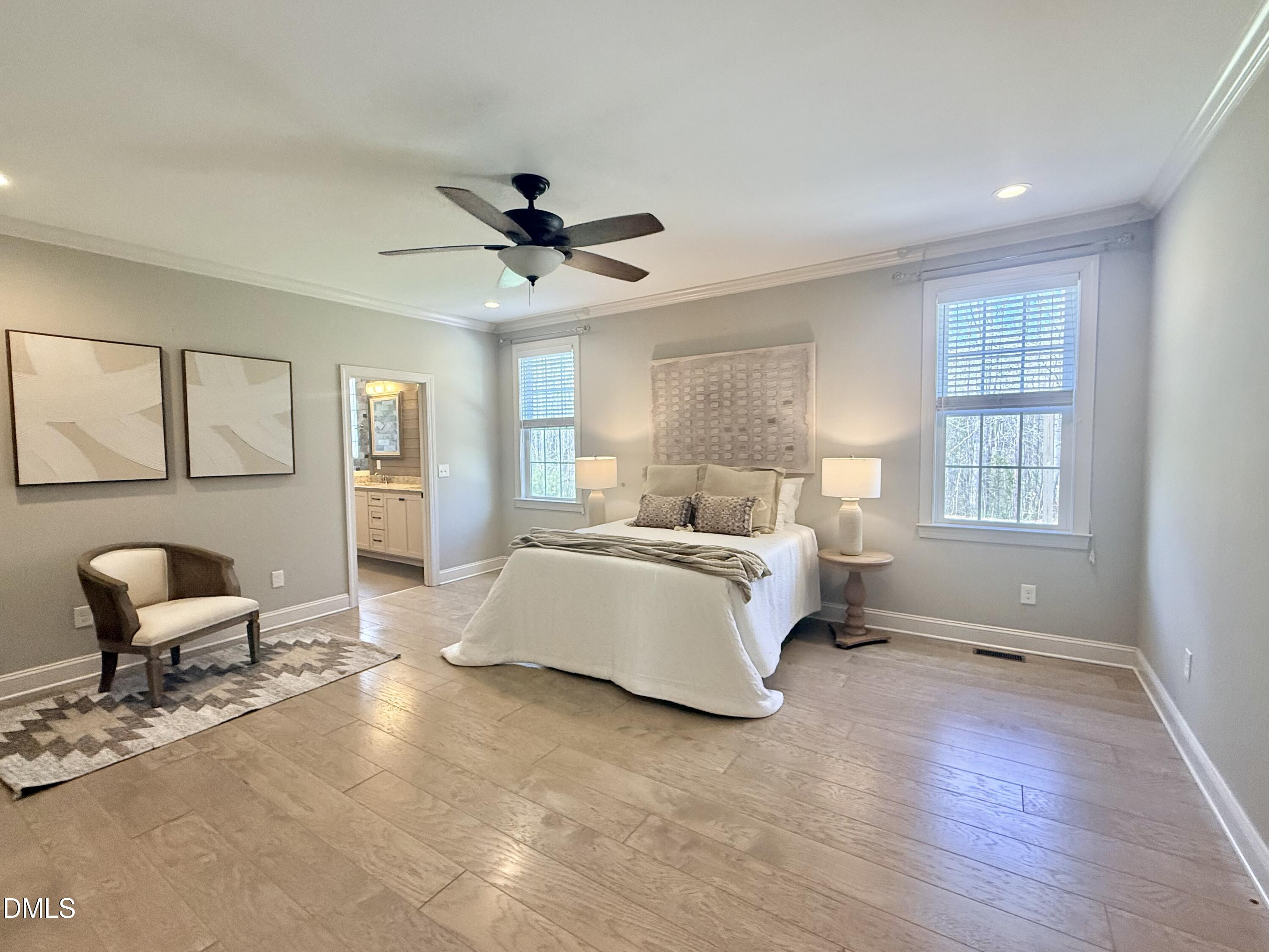 128 Bessie Lane Roxboro, NC 27574 - Photo 19 of 55 a spacious bedroom with a bed a couch and large window
