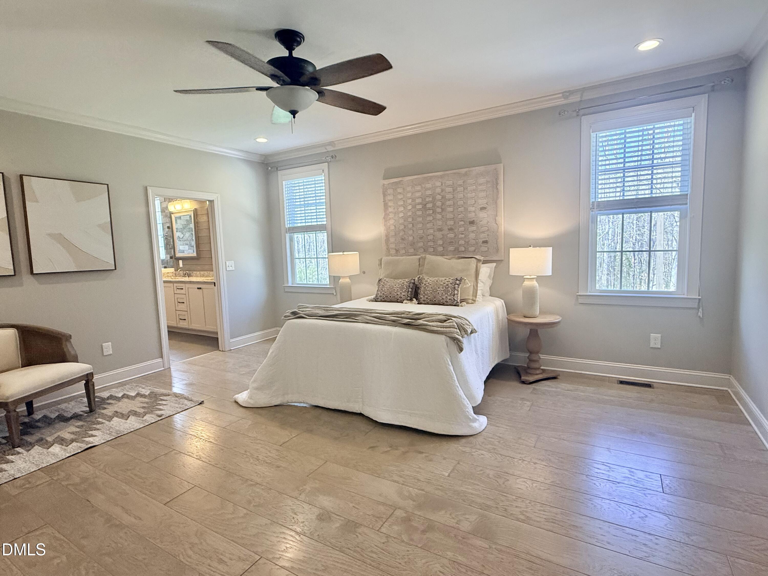 128 Bessie Lane Roxboro, NC 27574 - Photo 21 of 55 a spacious bedroom with a bed chandelier and windows