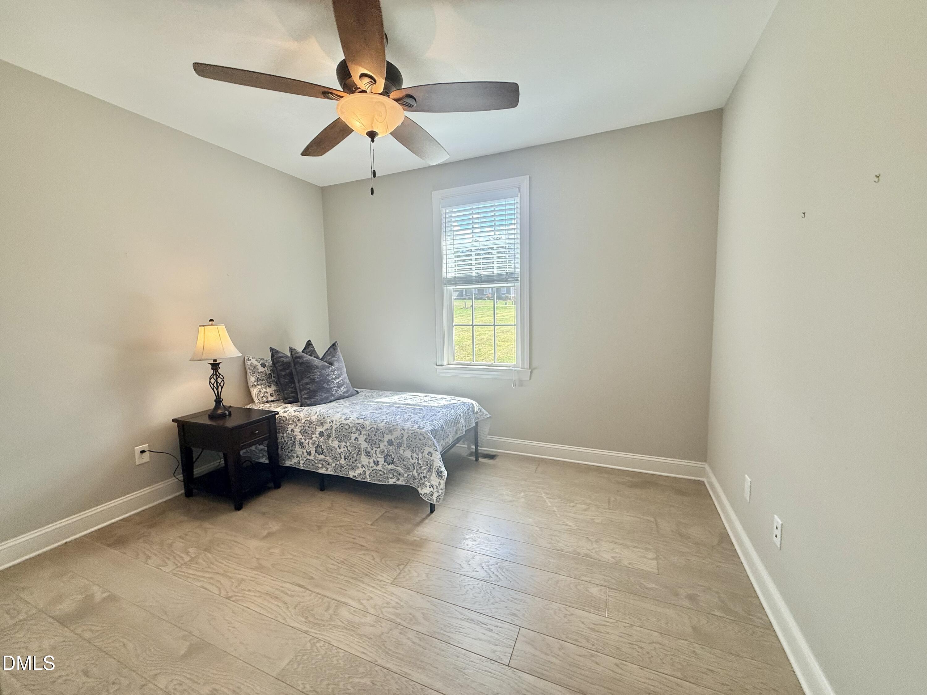 128 Bessie Lane Roxboro, NC 27574 - Photo 34 of 55 a bedroom with a bed and a ceiling fan
