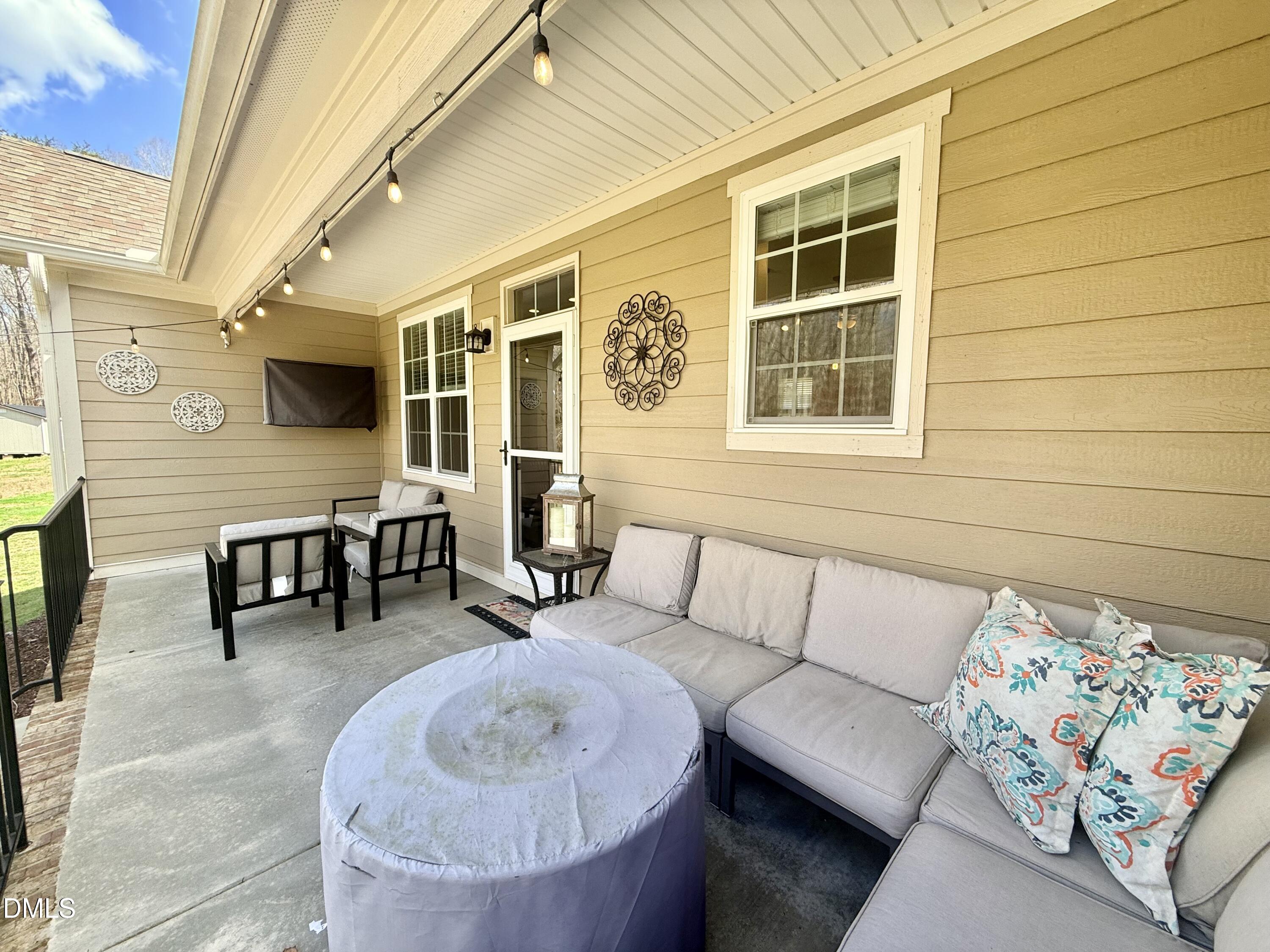 128 Bessie Lane Roxboro, NC 27574 - Photo 44 of 55 a outdoor living space with furniture and a flat screen tv