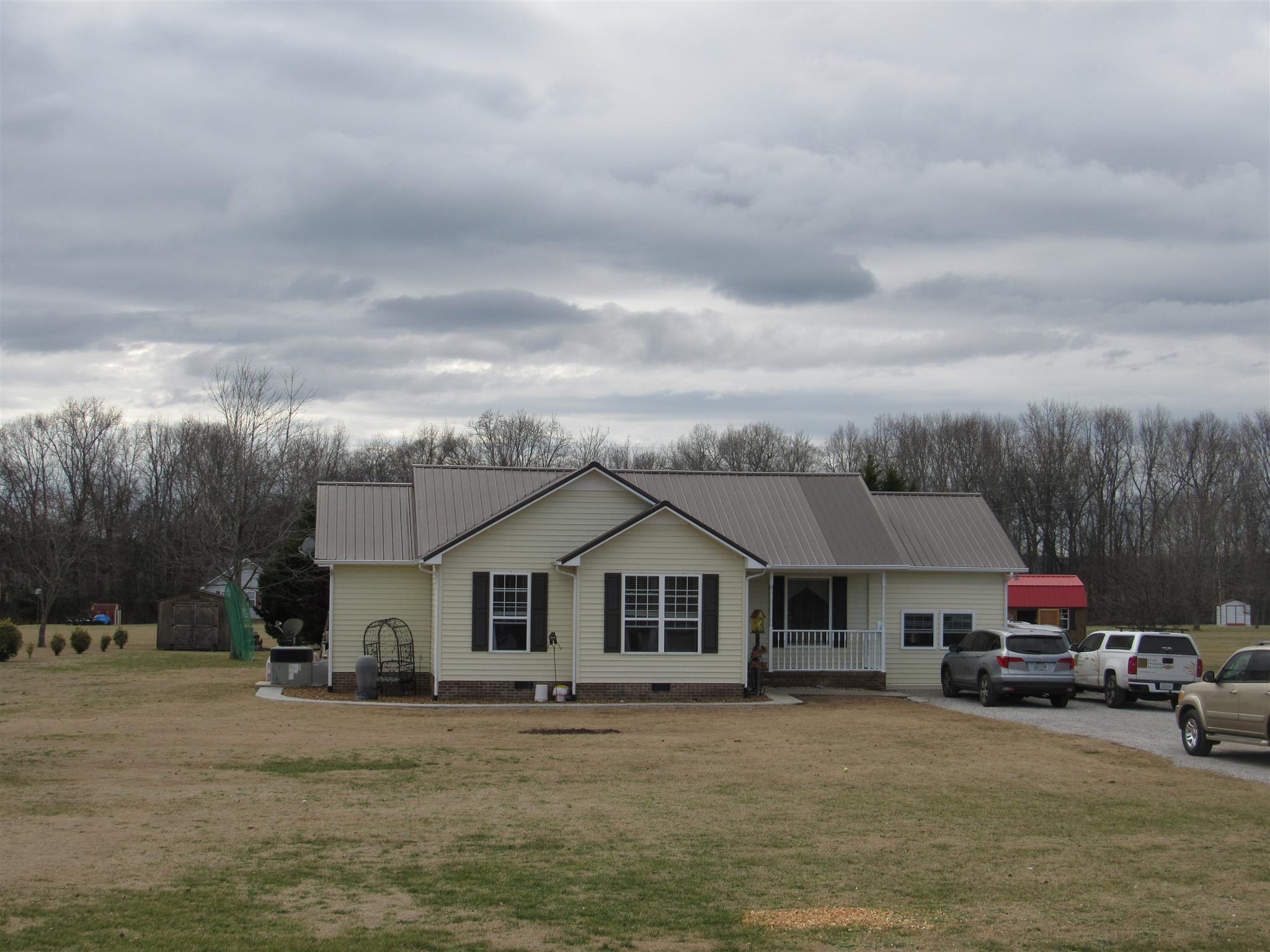 180 Benson Road Manchester, TN 37355 - Photo 3 of 15 a front view of a house with a garden and parking space