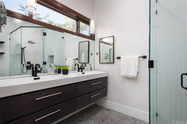 a bathroom with a double vanity sink and mirror