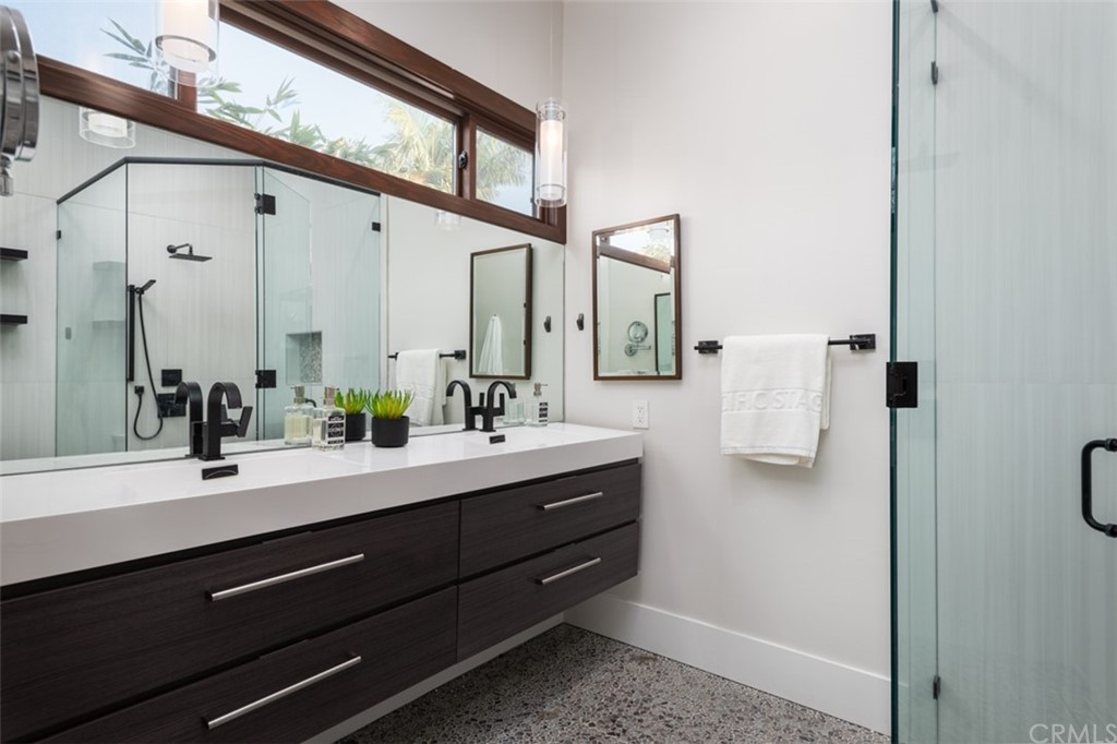 247 Emerald Bay Laguna Beach, CA 92651 - Photo 11 of 47 a bathroom with a double vanity sink and mirror