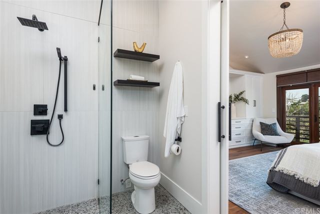 a bathroom with a granite countertop sink a toilet and a shower
