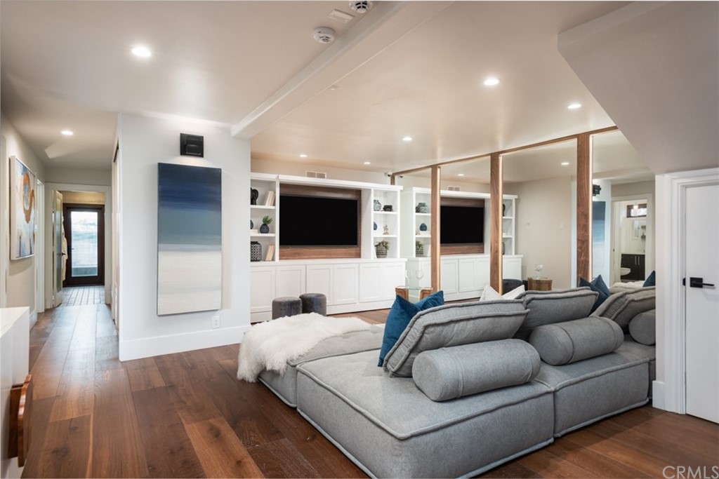 247 Emerald Bay Laguna Beach, CA 92651 - Photo 22 of 47 a living room with furniture and a flat screen tv