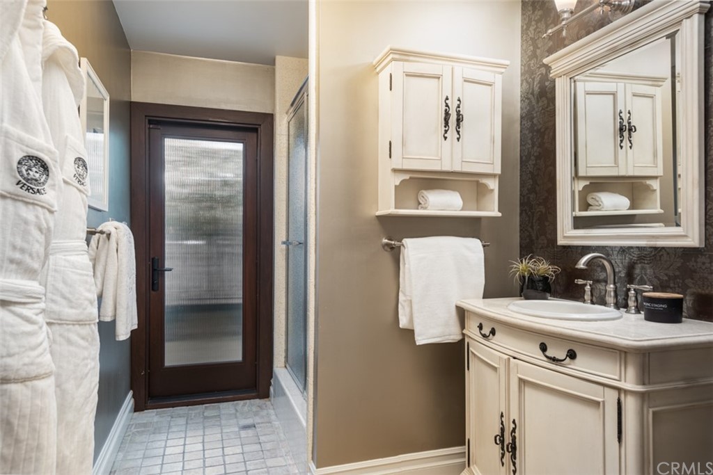 247 Emerald Bay Laguna Beach, CA 92651 - Photo 30 of 47 a bathroom with a sink and a mirror