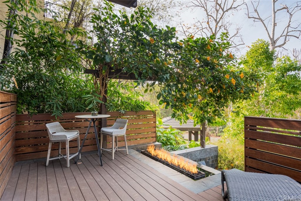 247 Emerald Bay Laguna Beach, CA 92651 - Photo 36 of 47 a view of a patio with table and chairs and wooden floor