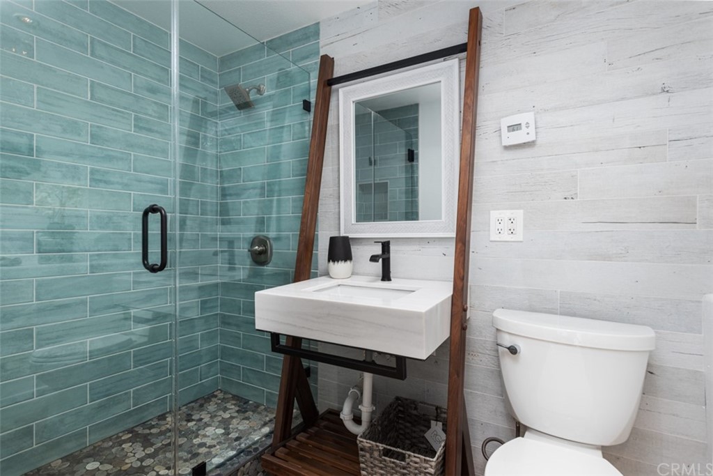 247 Emerald Bay Laguna Beach, CA 92651 - Photo 41 of 47 a bathroom with a toilet a sink and mirror
