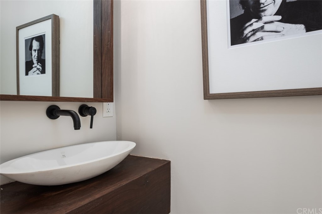 247 Emerald Bay Laguna Beach, CA 92651 - Photo 43 of 47 a bathroom with a sink and mirror