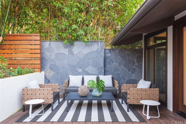a view of a patio with a table and chairs and potted plants