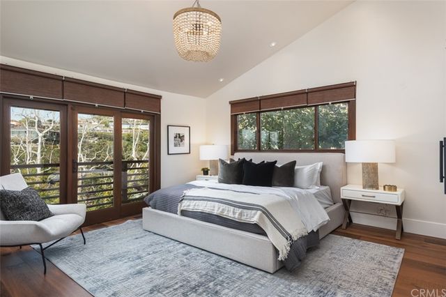 a bedroom with a large bed and a large window