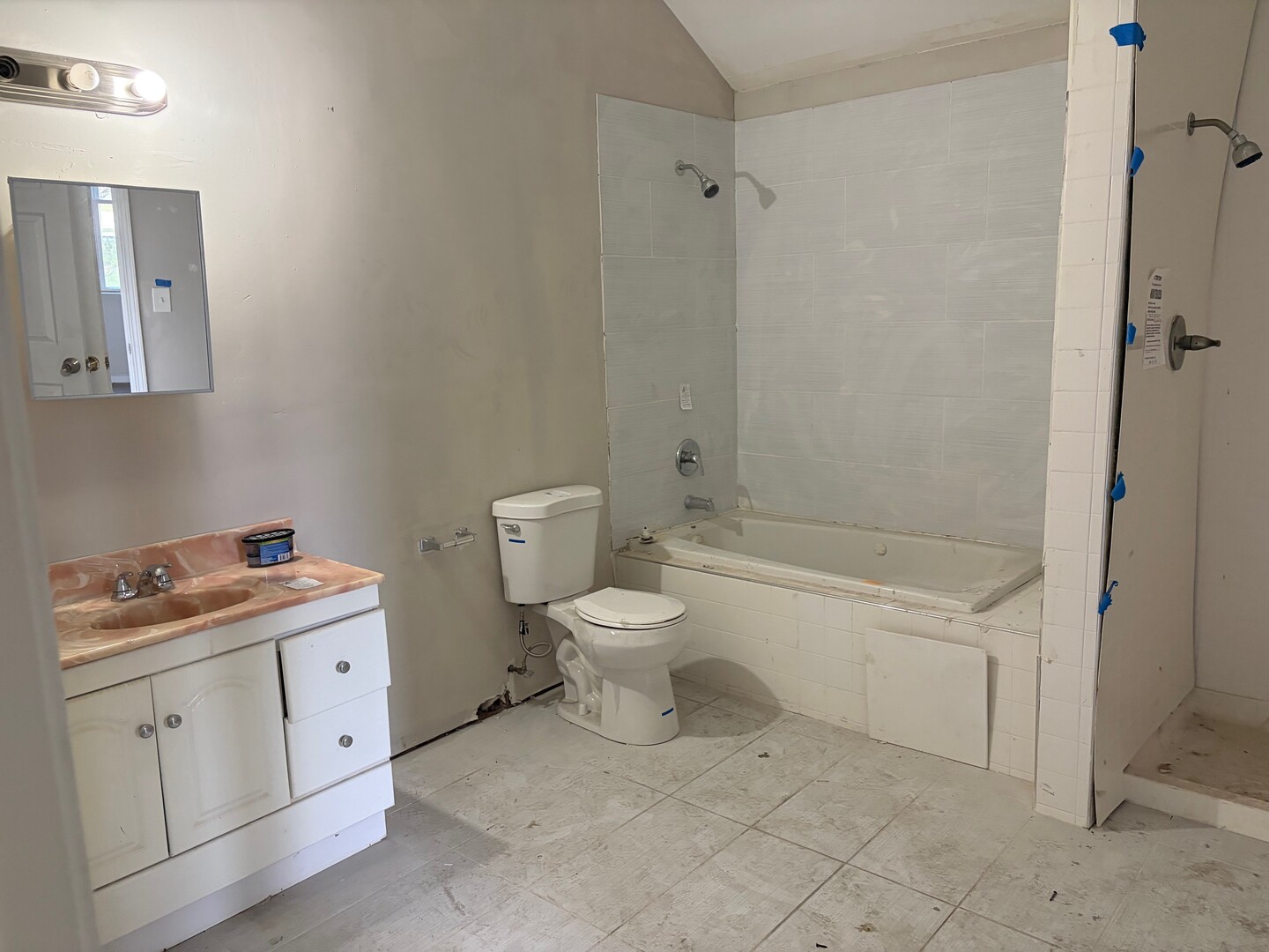 850 West 86th Place Chicago, IL 60620 - Photo 14 of 25 a bathroom with a granite countertop toilet a sink and a mirror