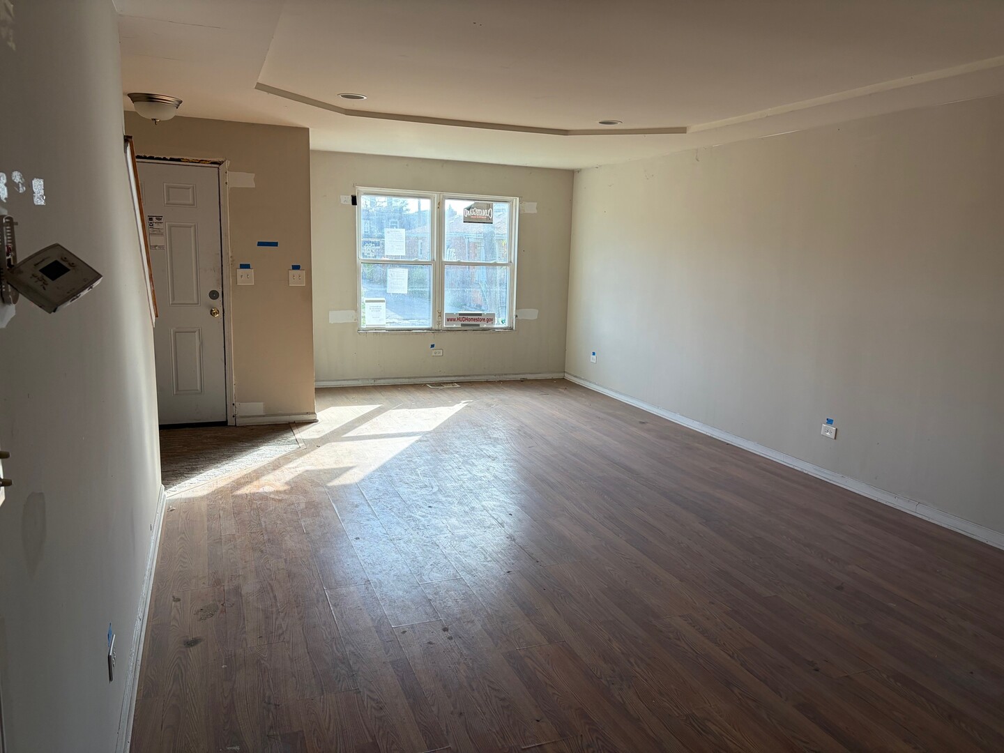 850 West 86th Place Chicago, IL 60620 - Photo 4 of 25 an empty room with wooden floor and windows