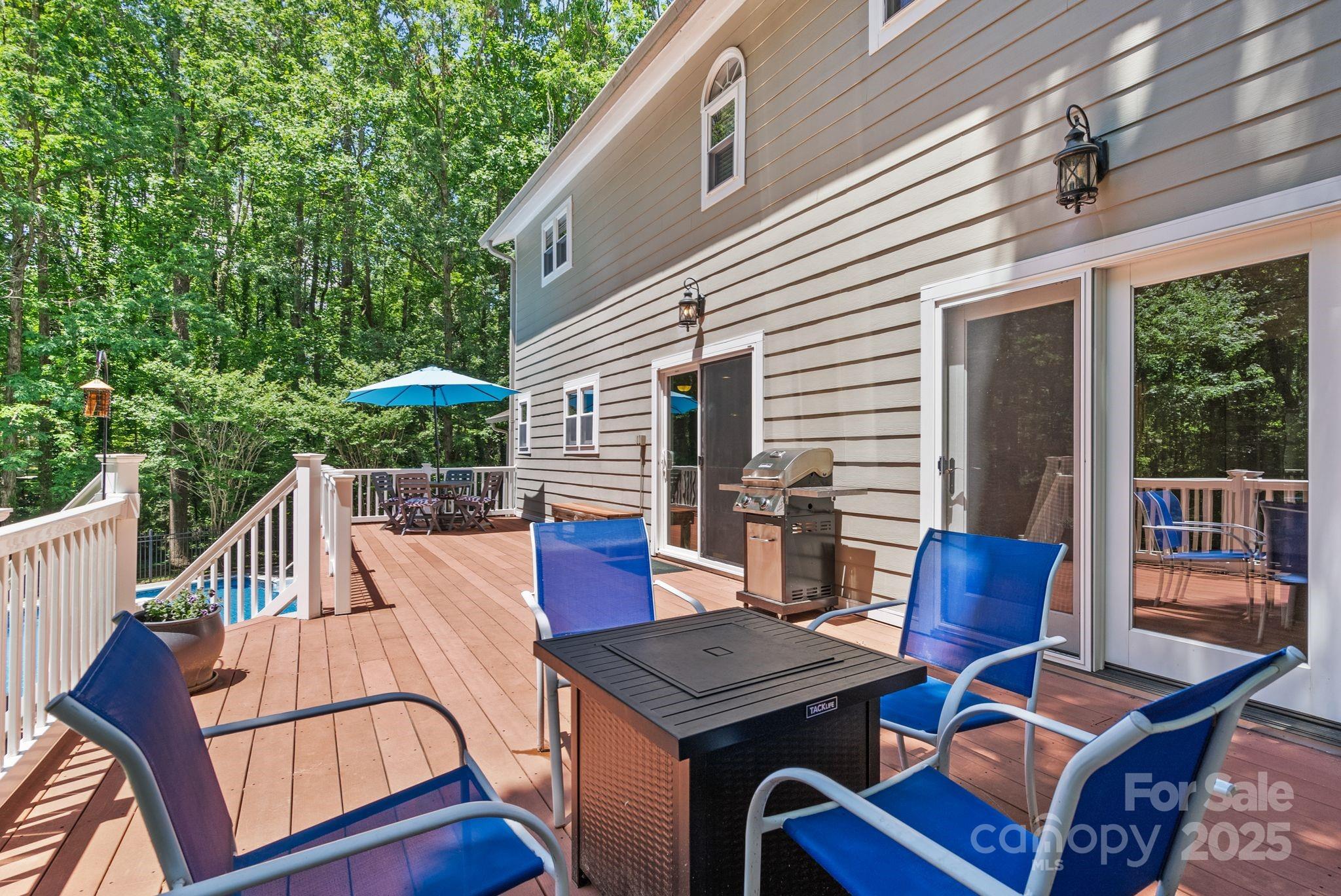 41 Glen Cove Road Arden, NC 28704 - Photo 12 of 39 a view of a patio with a dining table and chairs with wooden floor
