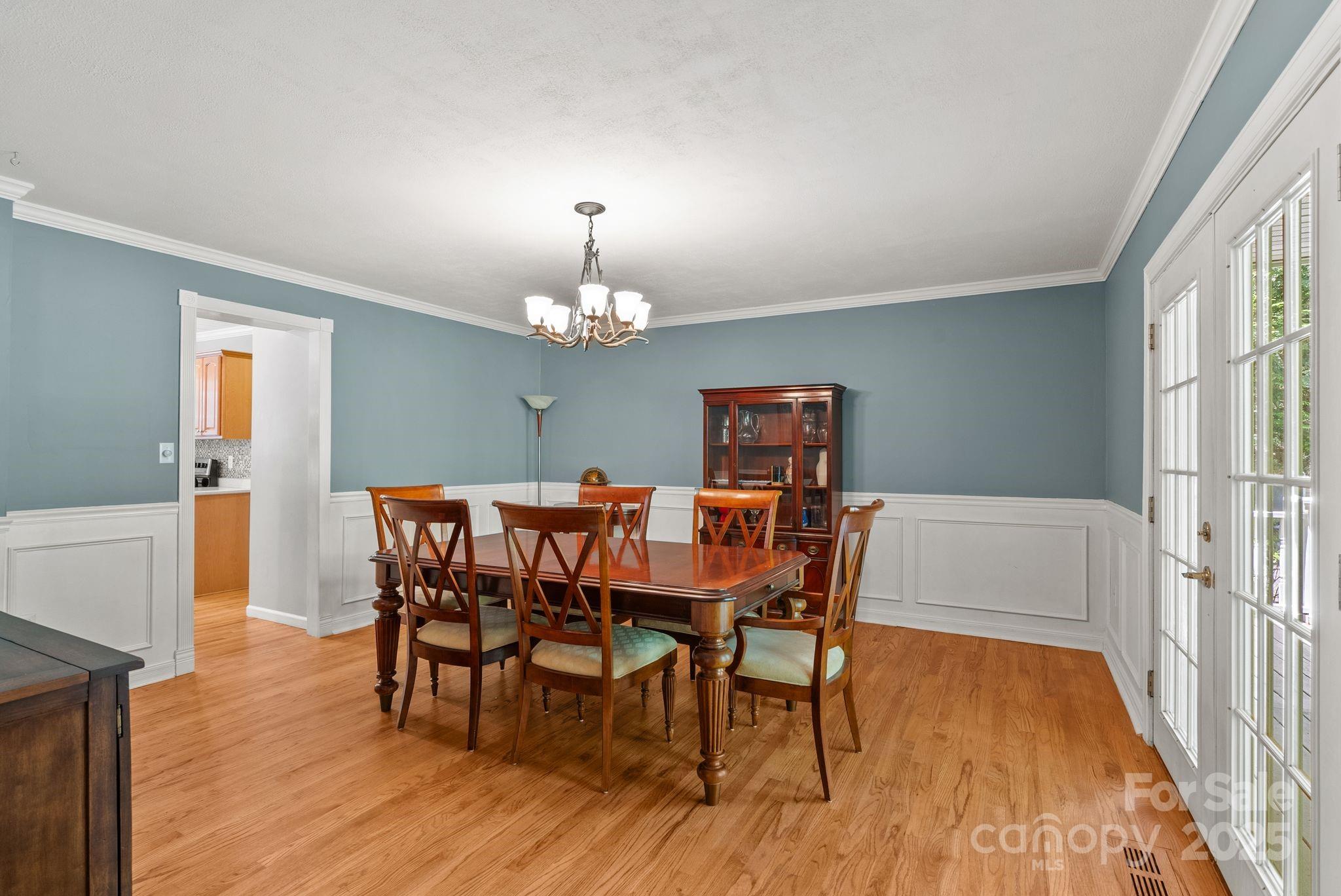 41 Glen Cove Road Arden, NC 28704 - Photo 13 of 39 a view of a dining room with furniture a chandelier and wooden floor
