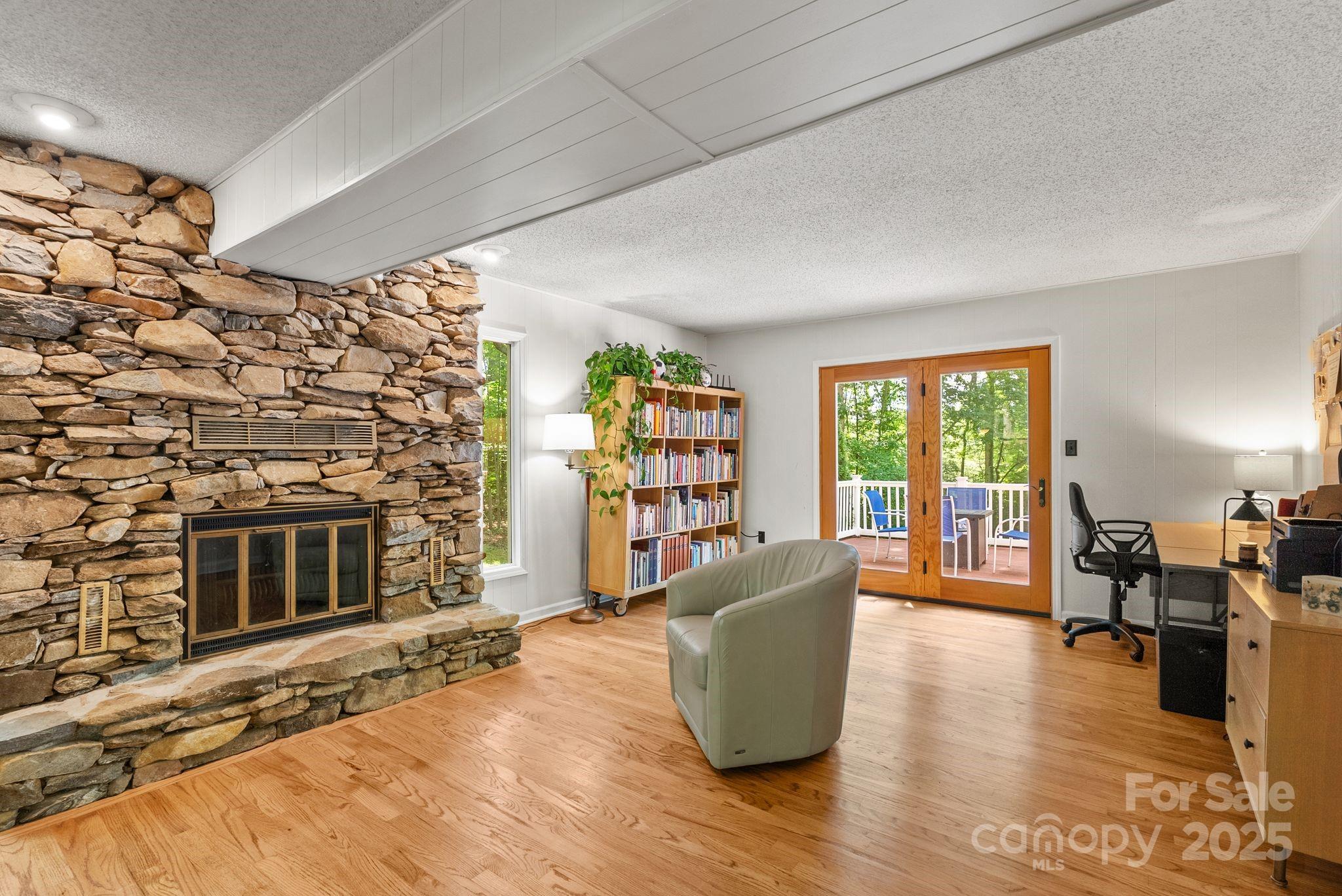 41 Glen Cove Road Arden, NC 28704 - Photo 17 of 39 a living room with fireplace furniture and a wooden floor