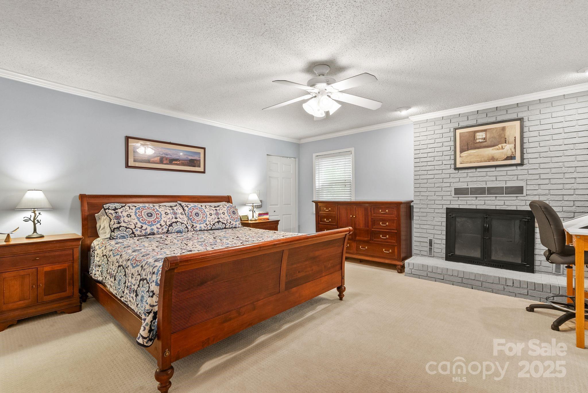 41 Glen Cove Road Arden, NC 28704 - Photo 24 of 39 a bed room with a bed and a fireplace