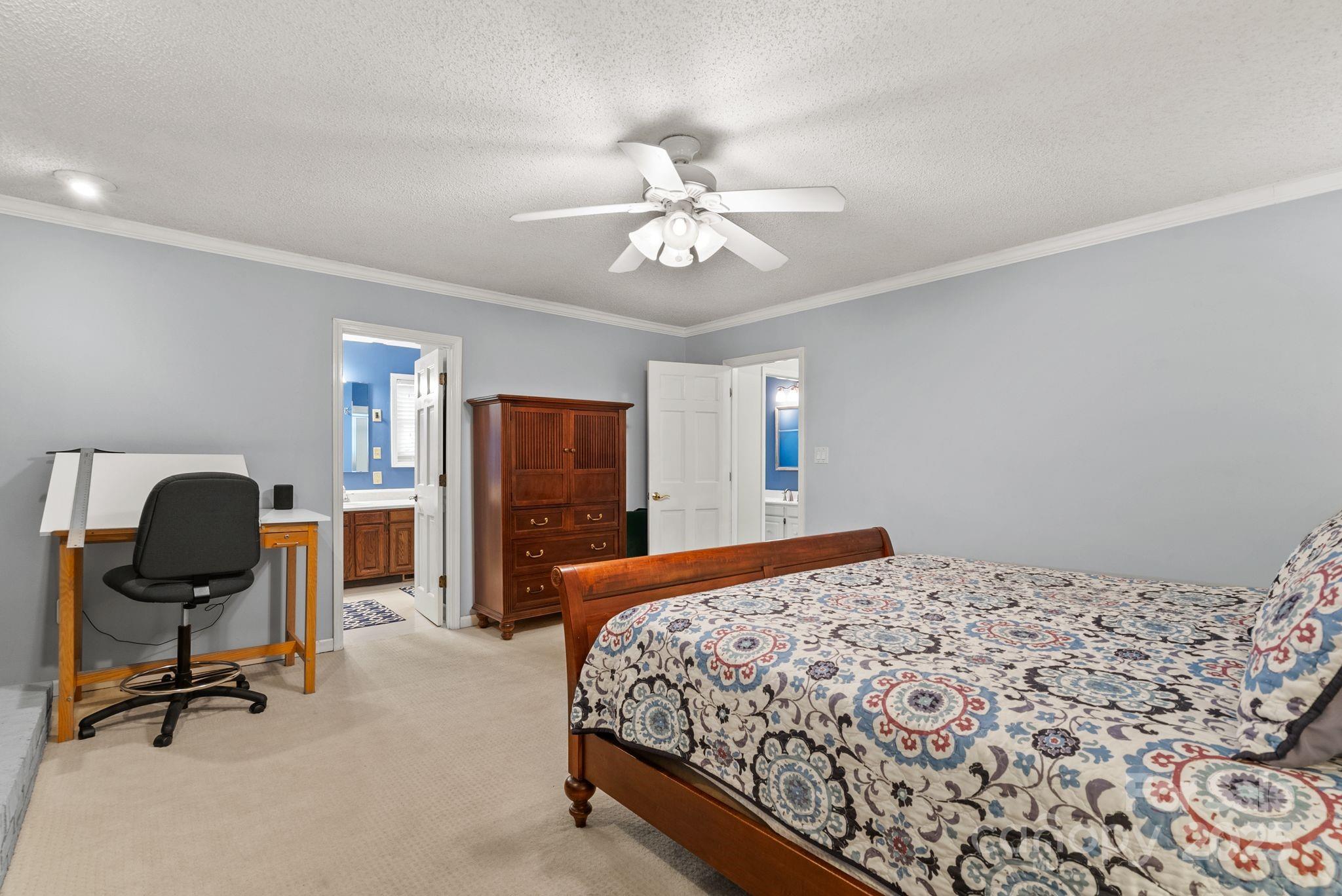 41 Glen Cove Road Arden, NC 28704 - Photo 25 of 39 a bedroom with a bed and a chandelier