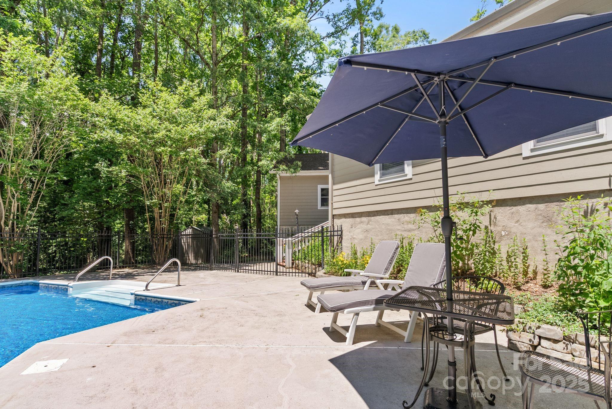 41 Glen Cove Road Arden, NC 28704 - Photo 35 of 39 a view of a patio with table and chairs under an umbrella