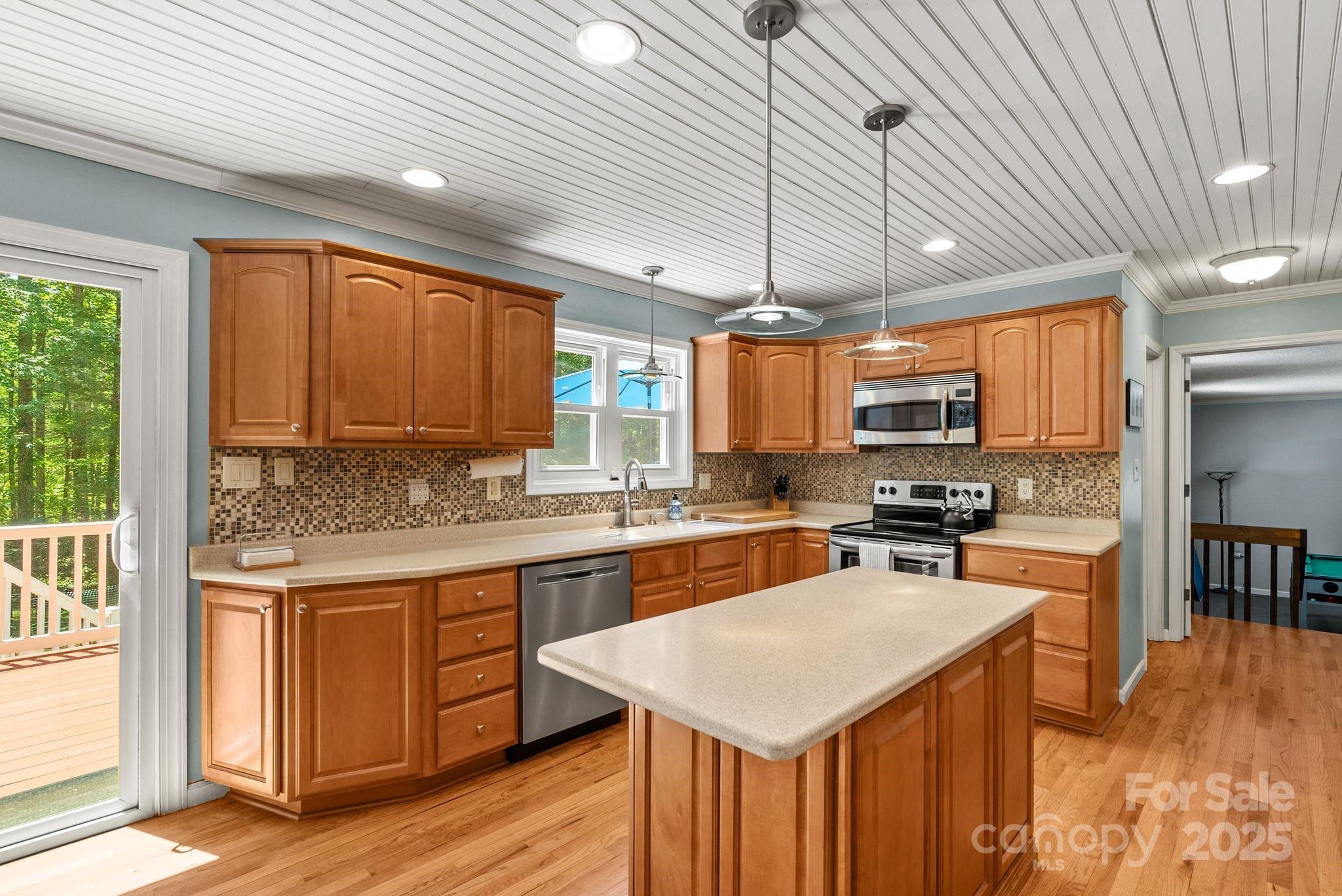 41 Glen Cove Road Arden, NC 28704 - Photo 8 of 39 a kitchen with stainless steel appliances a stove sink refrigerator dining table and chairs