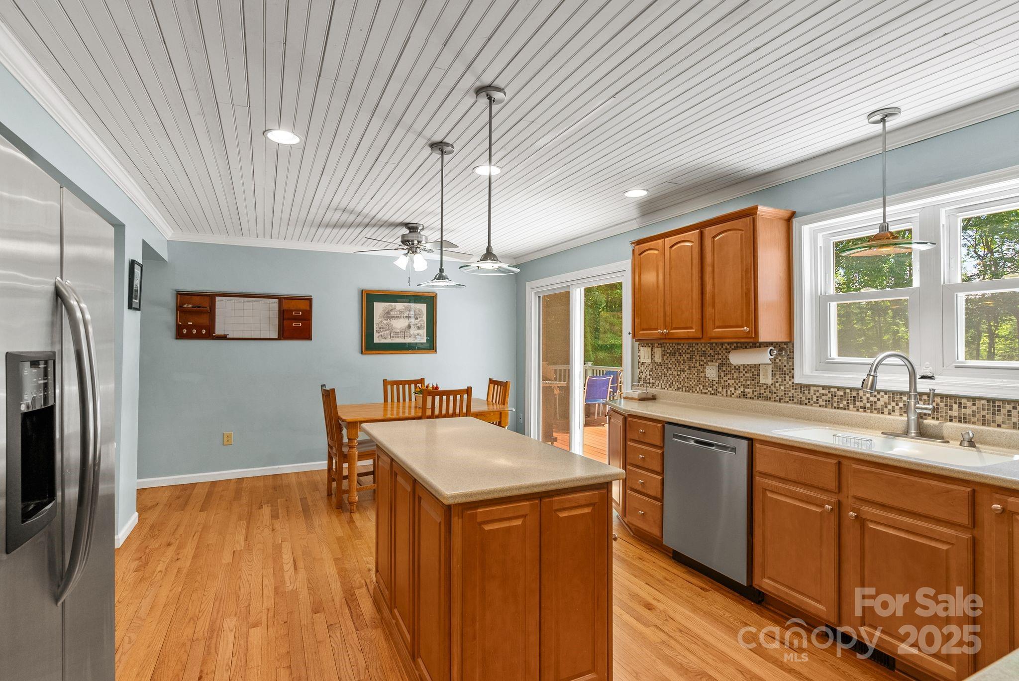 41 Glen Cove Road Arden, NC 28704 - Photo 9 of 39 a kitchen with stainless steel appliances granite countertop a sink a stove a refrigerator cabinets and wooden floor