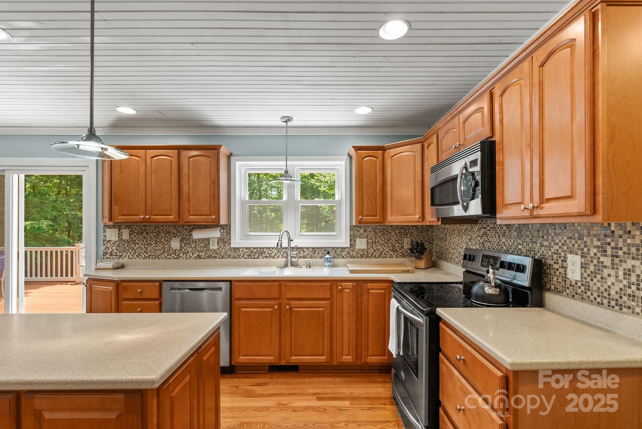 41 Glen Cove Road Arden, NC 28704 - Photo 10 of 39 a kitchen with a sink a stove and cabinets