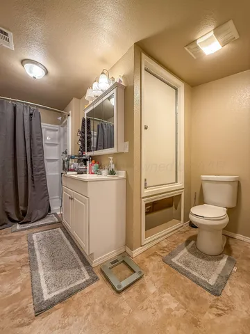 a living room with a couch and a stove top oven