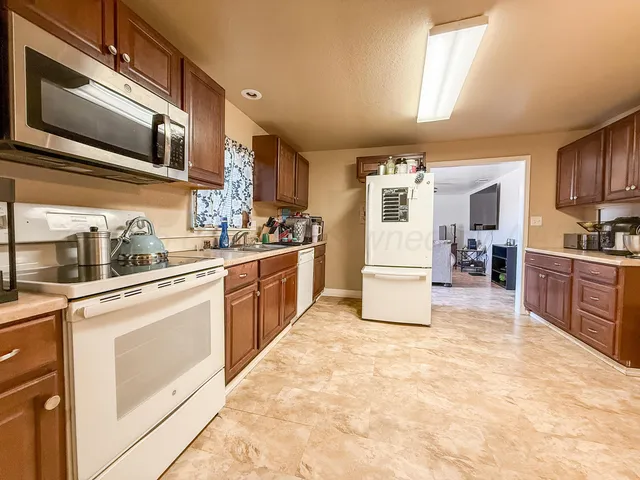 a kitchen with a sink cabinets and microwave