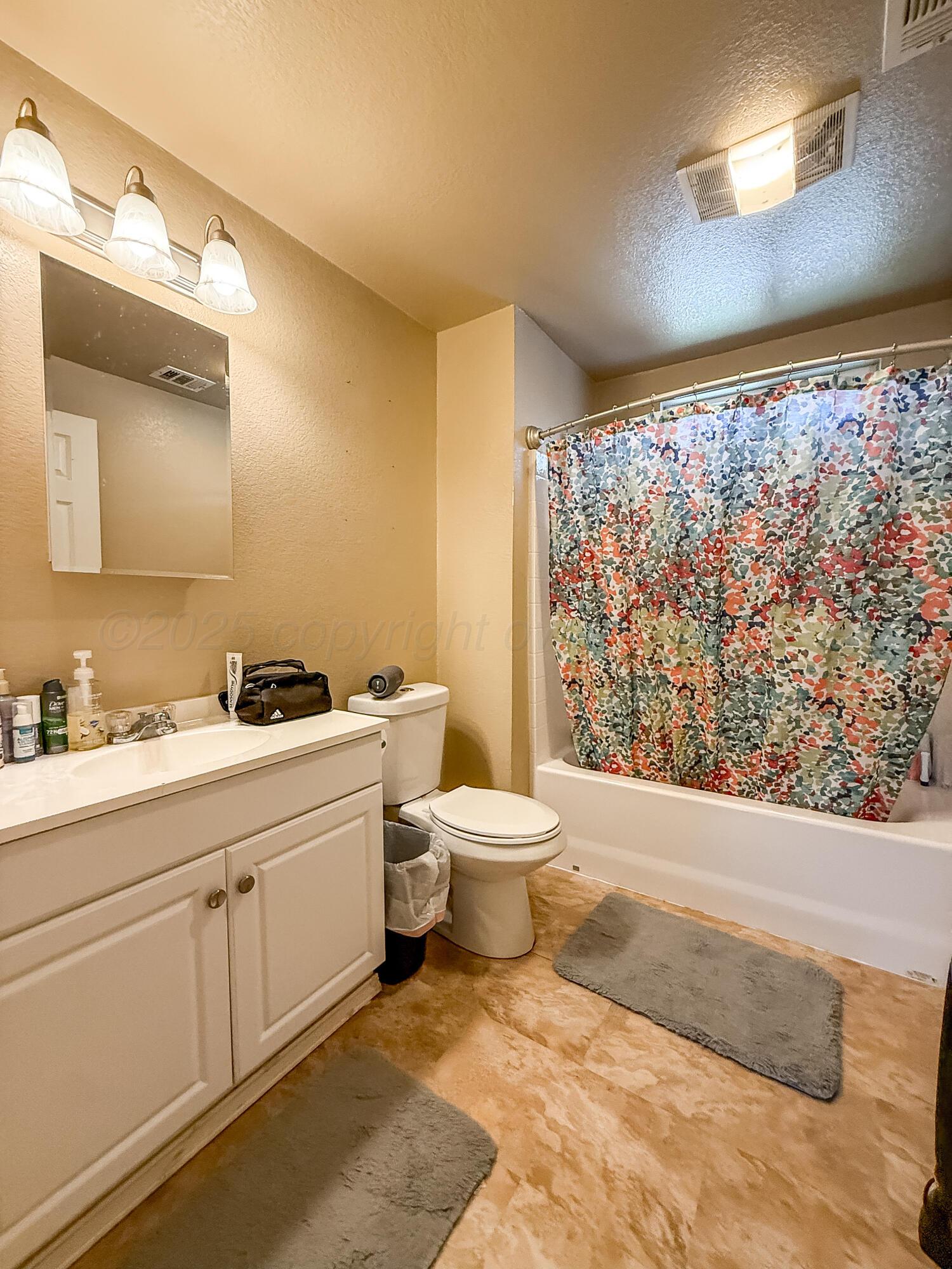 505 North Cedar Street Borger, TX 79007 - Photo 7 of 15 a bathroom with a toilet sink and mirror