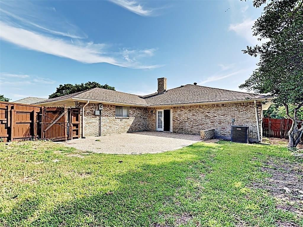 3413 Valley View Lane Garland, TX 75043 - Photo 12 of 12 a front view of a house with a yard and garage