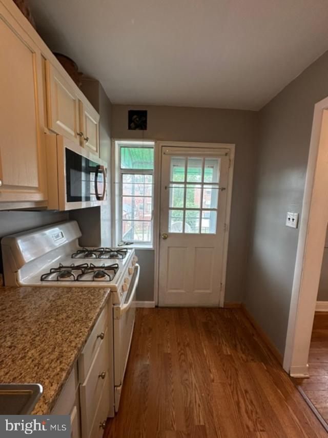 1619 Inverness Avenue Baltimore, MD 21230 - Photo 24 of 30 a kitchen with granite countertop a stove a sink and a microwave