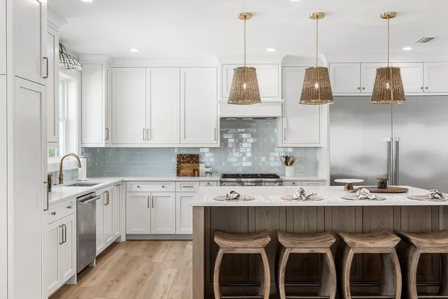 a kitchen with kitchen island granite countertop a sink a center island stainless steel appliances and cabinets