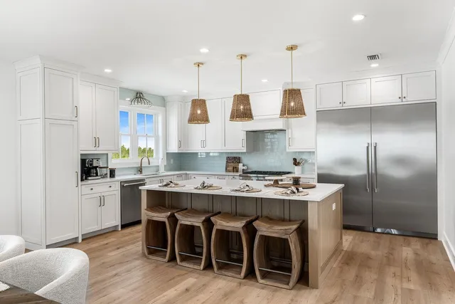 a kitchen with a sink a stove and cabinets