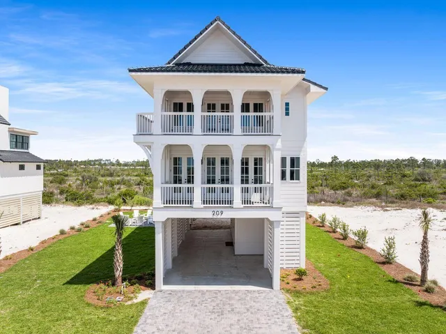 a view of staircase with white walls and a wooden floor