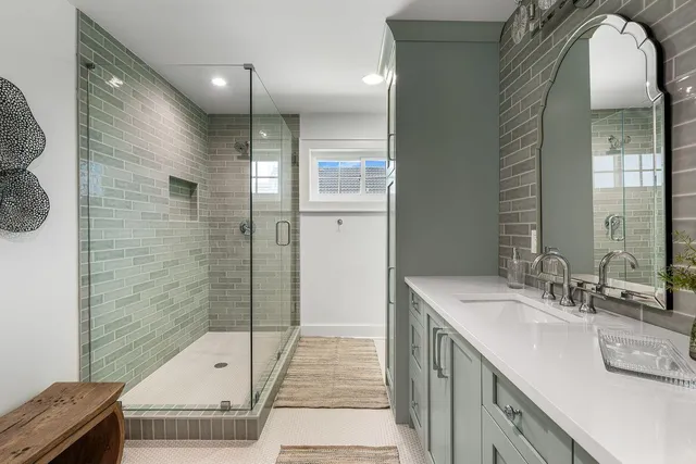 a view of a hallway with wooden floor and a bathroom