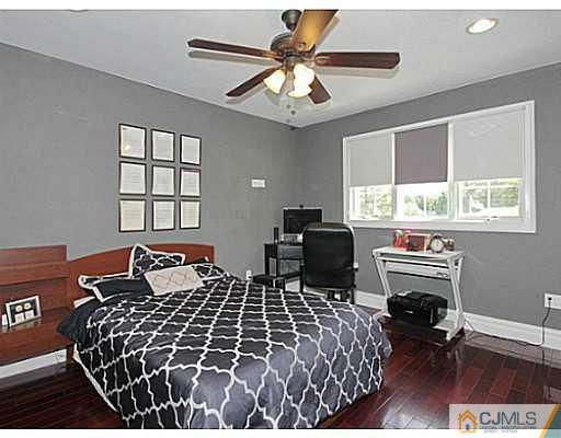 1881 Raritan Road Scotch Plains, NJ 07076 - Photo 11 of 18 a bedroom with a bed and a chandelier