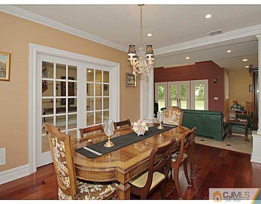 1881 Raritan Road Scotch Plains, NJ 07076 - Photo 3 of 18 a dining room with furniture a chandelier and wooden floor