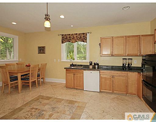 1881 Raritan Road Scotch Plains, NJ 07076 - Photo 5 of 18 a open kitchen with granite countertop a stove a sink a dining table and chairs