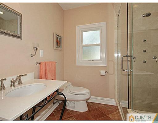 1881 Raritan Road Scotch Plains, NJ 07076 - Photo 8 of 18 a bathroom with a sink toilet and shower