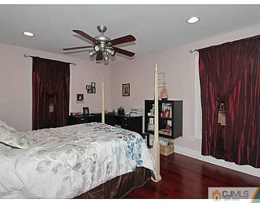 1881 Raritan Road Scotch Plains, NJ 07076 - Photo 9 of 18 a bedroom with a bed and a chandelier