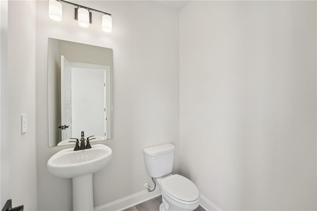 6440 Pinin Place Cumming, GA 30041 - Photo 36 of 52 a bathroom with a sink a toilet and mirror