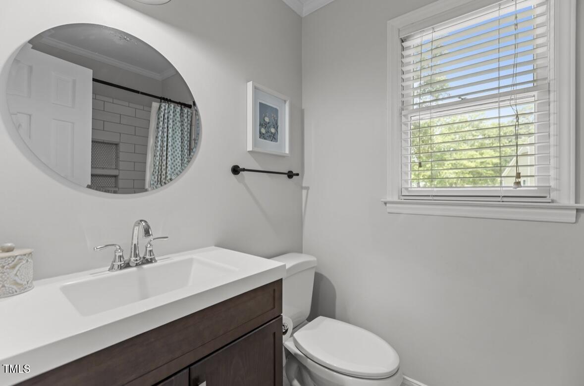 7517 Chippenham Court Raleigh, NC 27613 - Photo 16 of 43 a bathroom with a sink a toilet and mirror