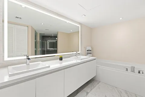 a bathroom with a sink and a large mirror