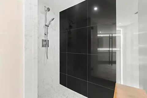 a bathroom with a glass shower door
