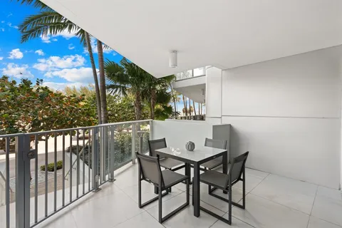 a view of a chairs and table in the balcony