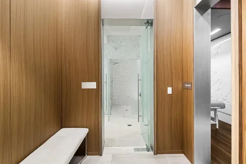 a bathroom with a bathtub sink and mirror