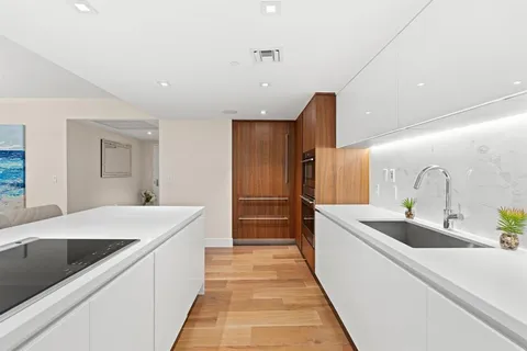 a kitchen with stainless steel appliances a sink and a refrigerator
